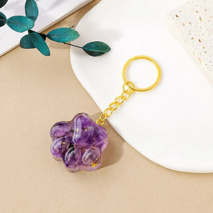 Natural crystal cat's paw keychain pendant showing gemstone options with integrated attachment loop