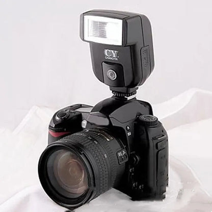 Compact black SLR camera flash unit with head tilted upwards, showing hot shoe mount.