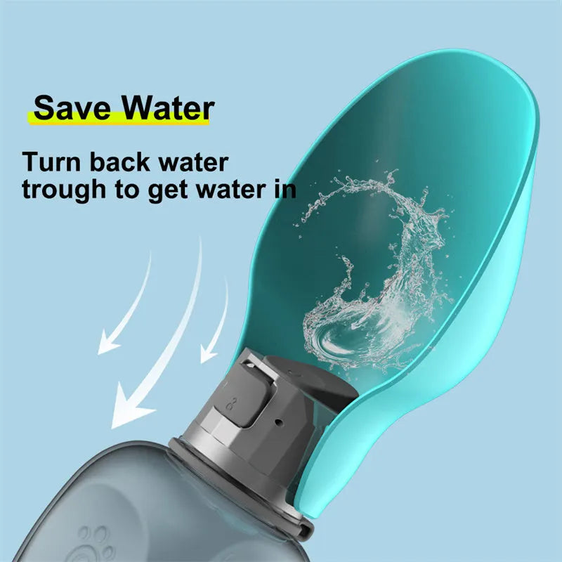 Blue grey portable dog water bottle with foldable drinking bowl and wrist strap, shown next to a dog.