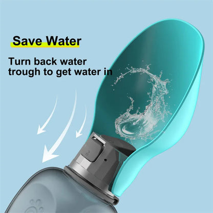 Blue grey portable dog water bottle with foldable drinking bowl and wrist strap, shown next to a dog.