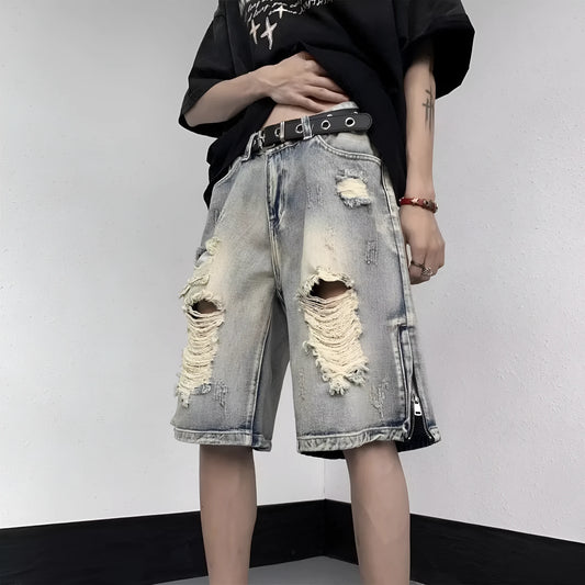 Blue denim shorts with wide-leg cut and tattered retro detailing on mannequin