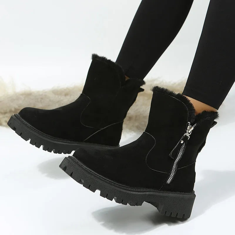 Women's black high top snow boots with a faux suede upper and side zipper on a white background.