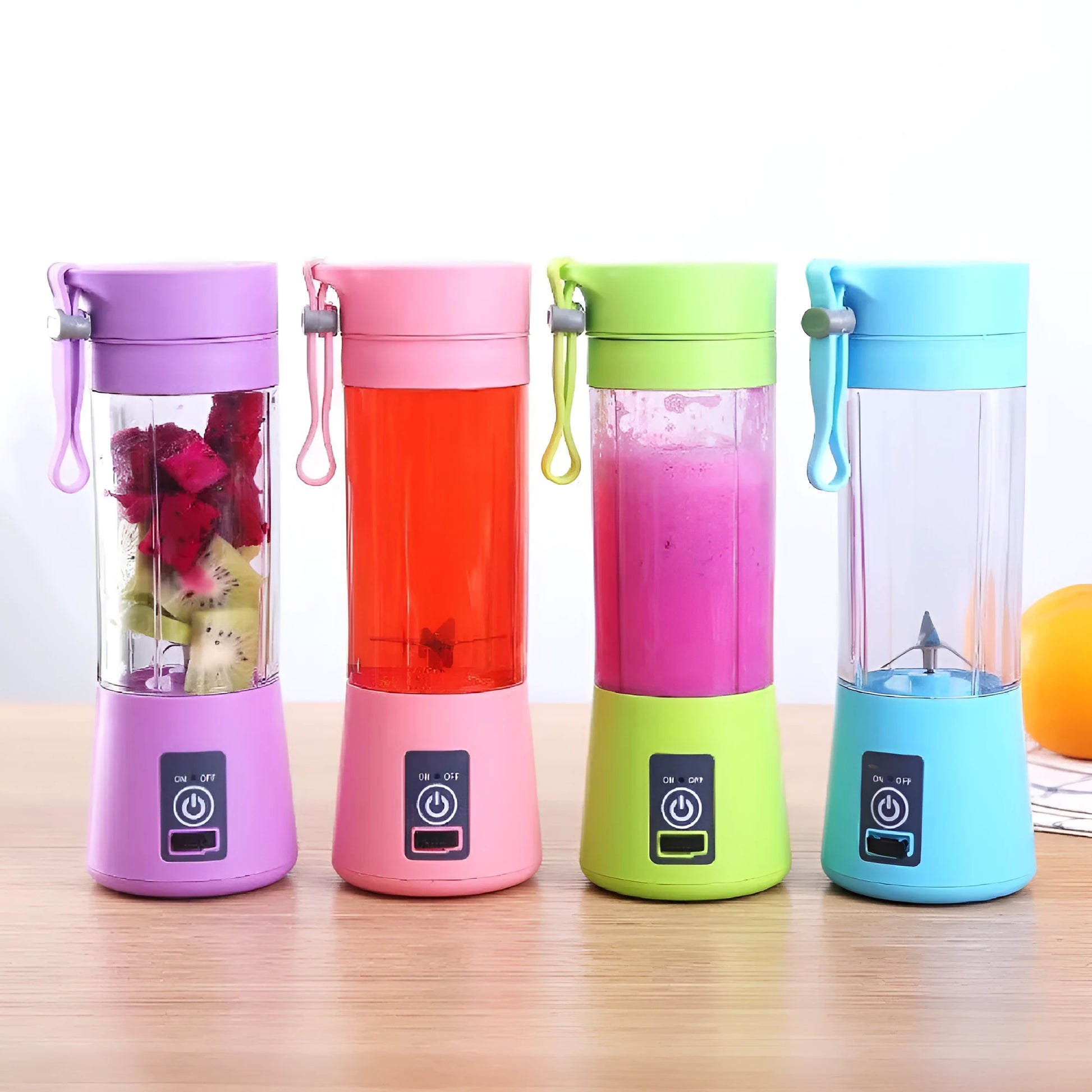 Compact pink portable blender with USB charging cable and box, shown alongside blended fruit smoothie.