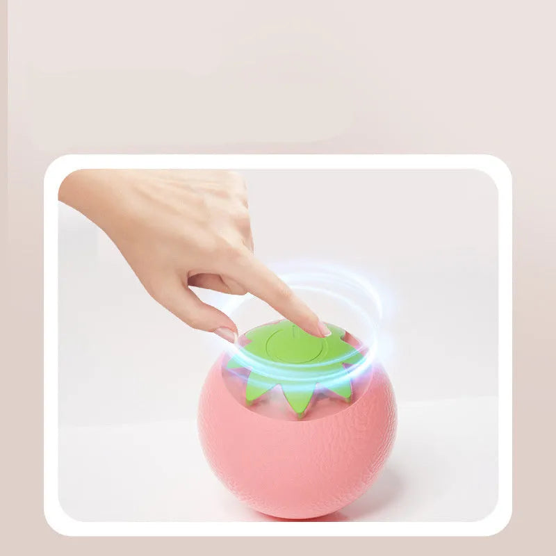 Green automatic rotating ball pet toy for dogs and cats on indoor flooring