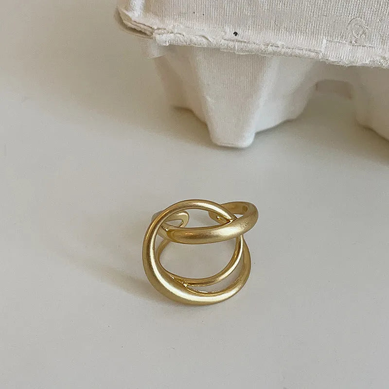 Geometric open ring with interlaced pattern and matte finish, adjustable for finger sizes 16mm to 20mm