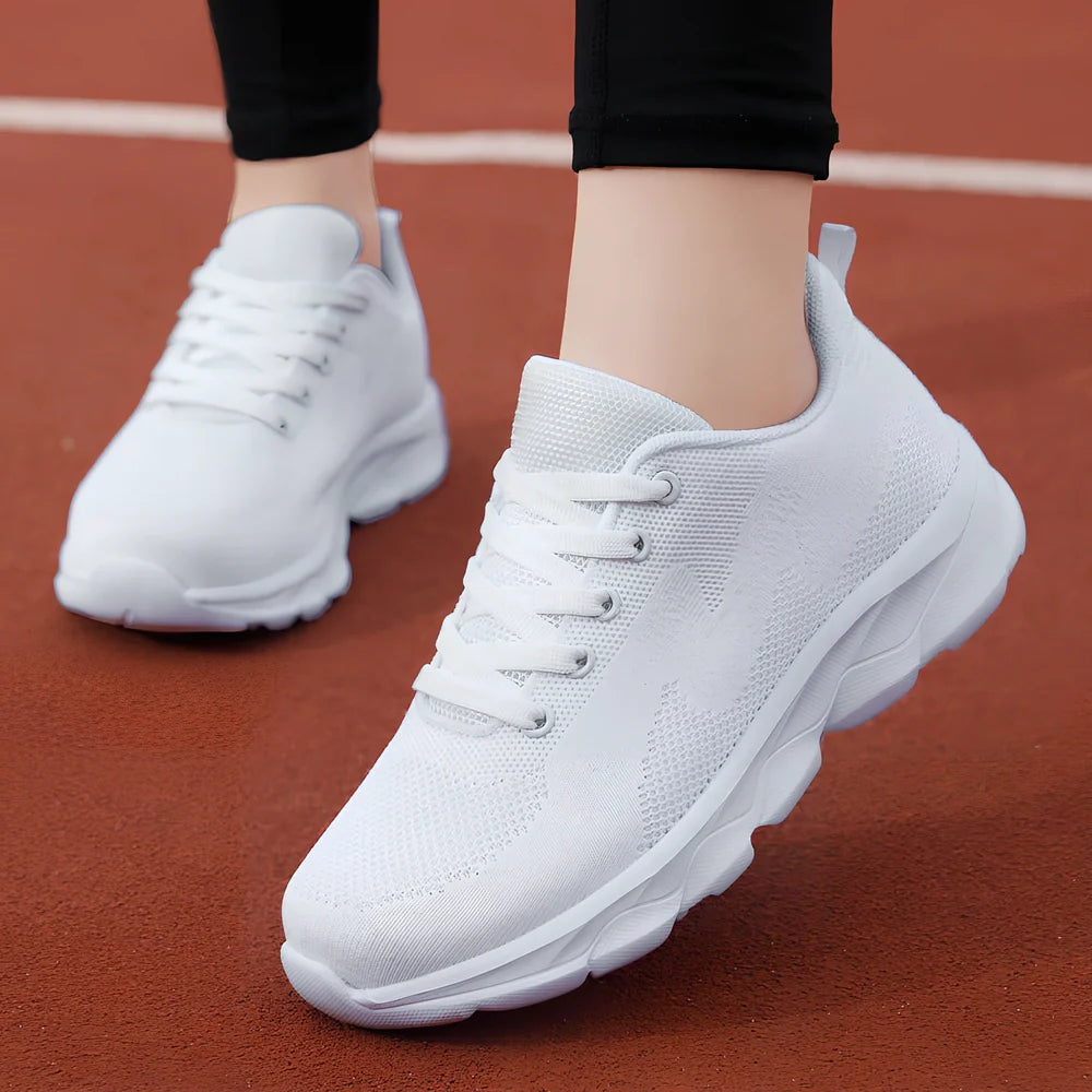 Women's black sneakers with mesh upper, wedge heel, and lace-up front