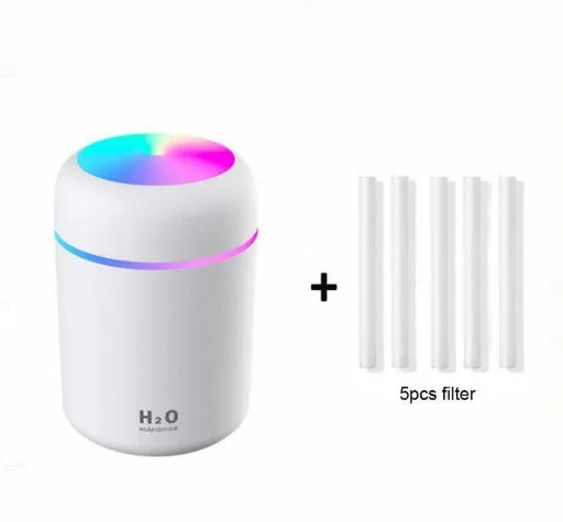 Pink car air purifying humidifier with LED lights on, next to a USB cable.