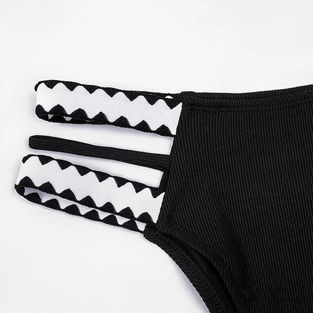 Black hollowed-out split briefs swimsuit for women made from polyester fabric