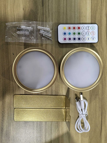 Black magnetic LED painting lamp with remote control on a white wall.