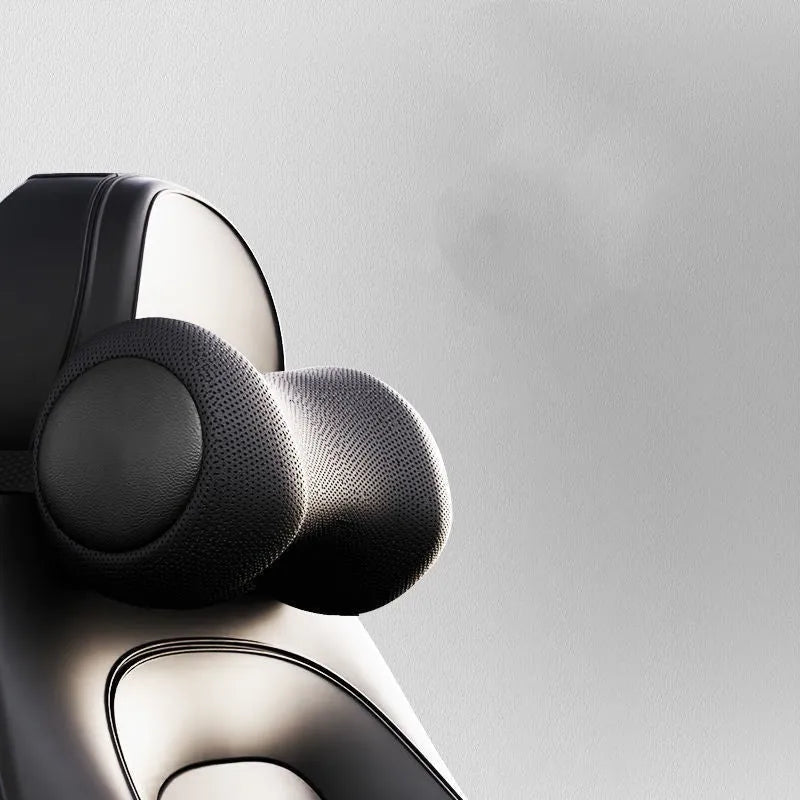 Black car massage cushion with adjustable straps attached to a car seat headrest