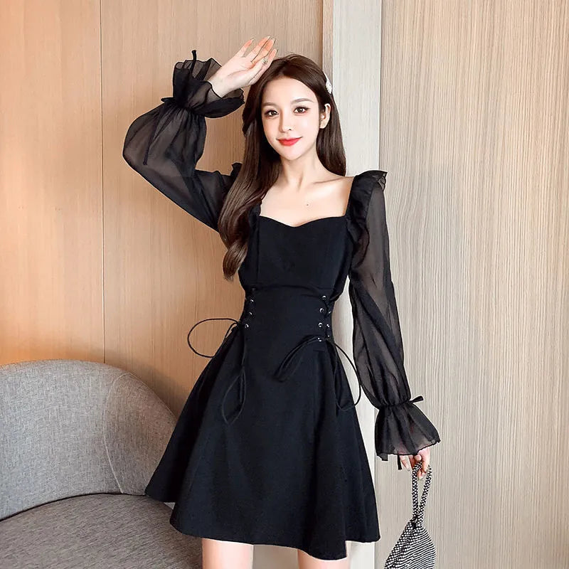 White chiffon patchwork dress with long sleeves and a waist-slimming design on a mannequin.