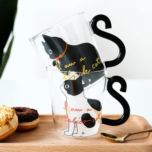 Adorable cat-shaped glass mug in black and white colors, perfect for coffee, tea, or juice