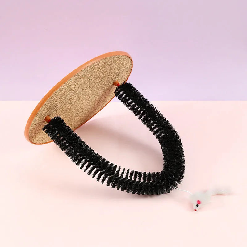 Black arch-shaped cat grooming brush with scratching fibre and an attached mouse toy on a non-slip base