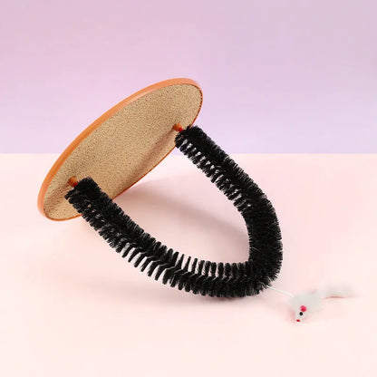 Black arch-shaped cat grooming brush with scratching fibre and an attached mouse toy on a non-slip base