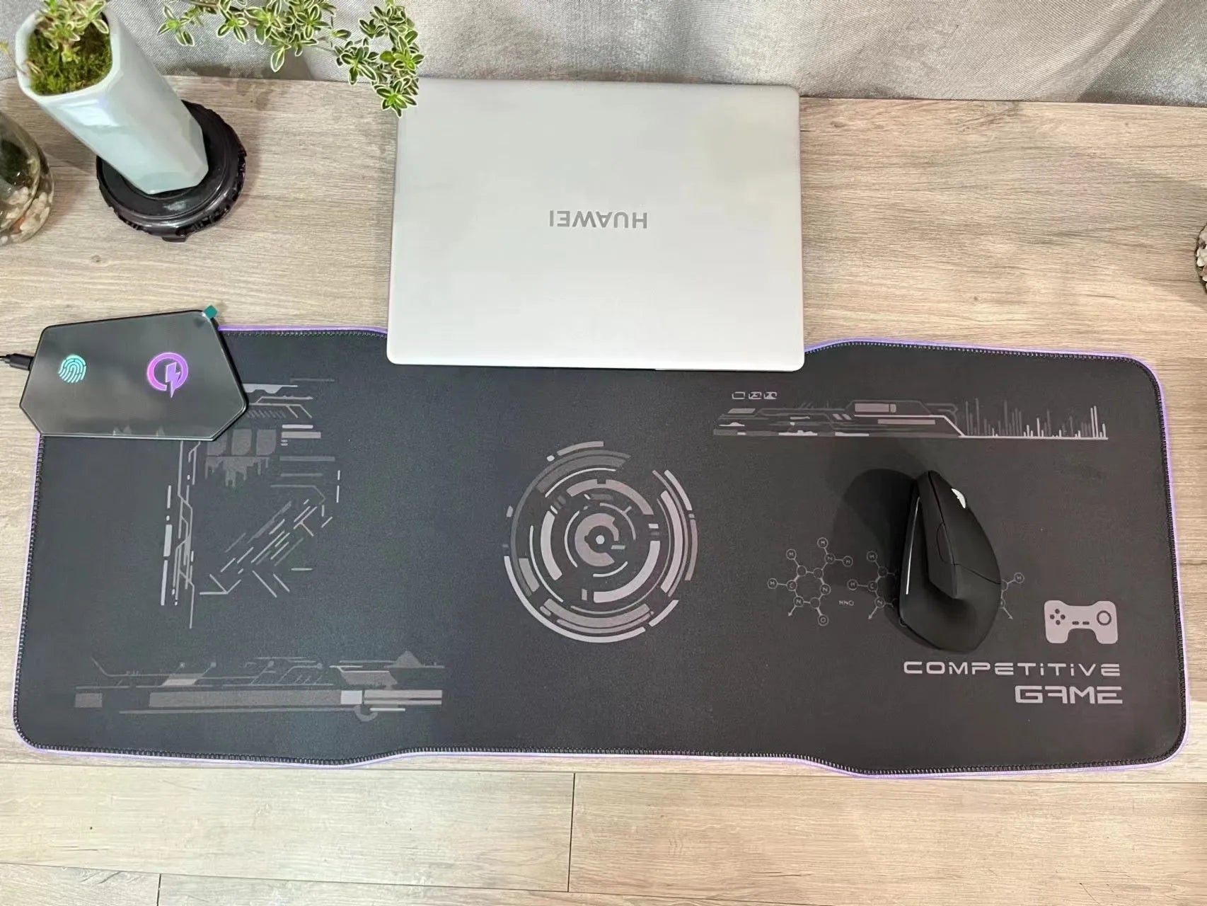 Black luminous gaming mouse mat with mech style graphics, water-repellent cloth surface, and USB cable