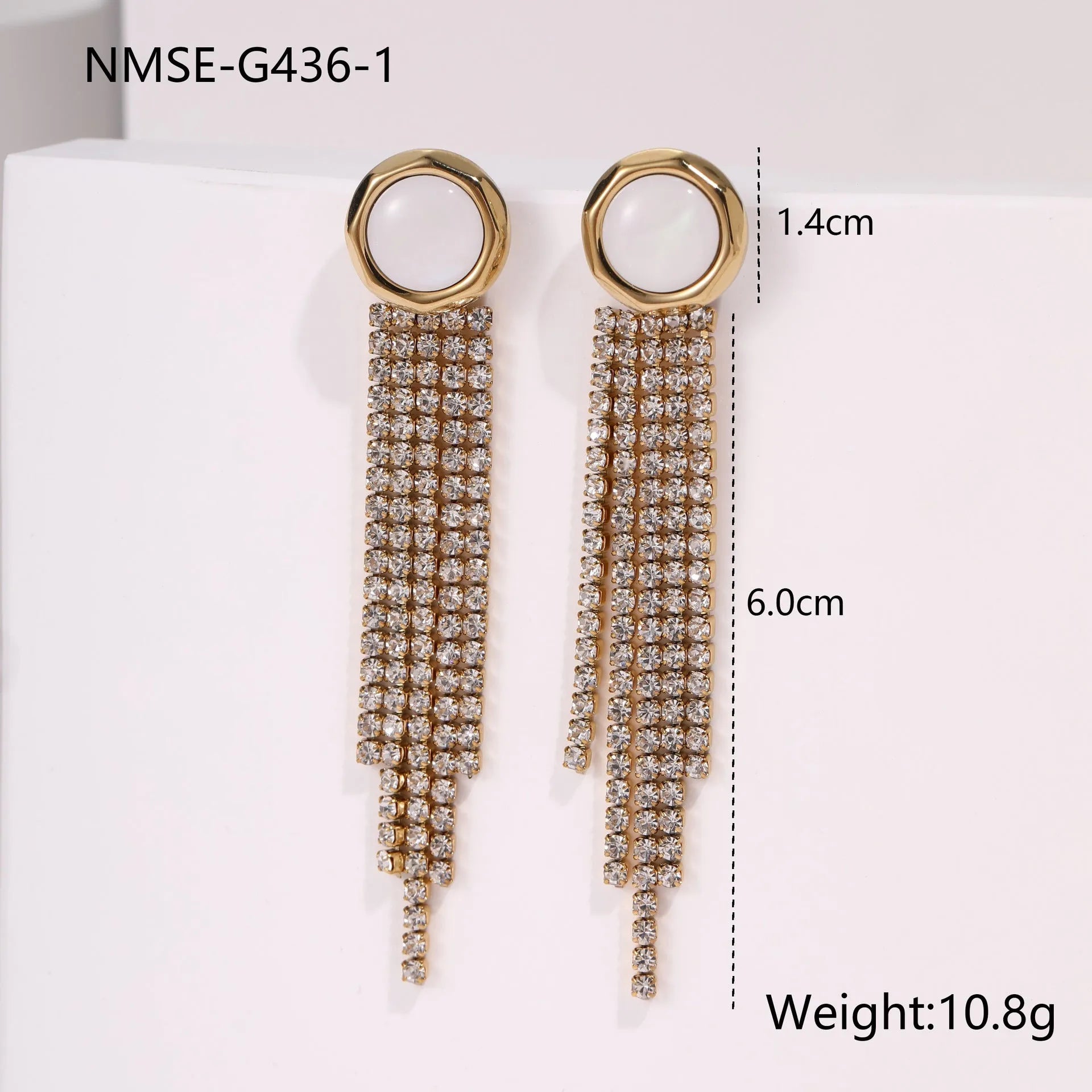 Gold-coloured women's earrings with a love heart shape, star details and dangling diamond-style tassels on a white background.