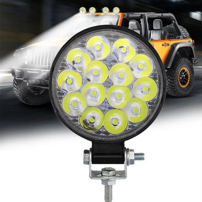 Small round white aluminium LED work light with IP67 rating for automotive use.