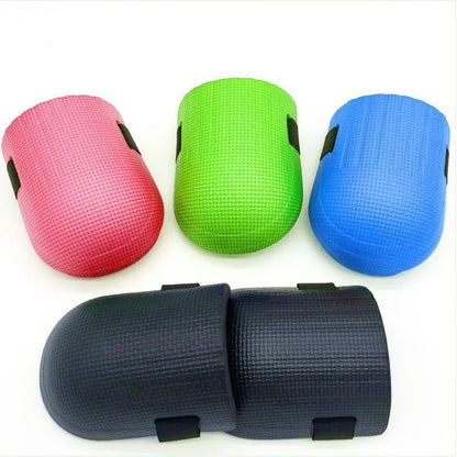A pair of EVA foam kneepads in black, blue, green, and pink options for construction and auto repair work.