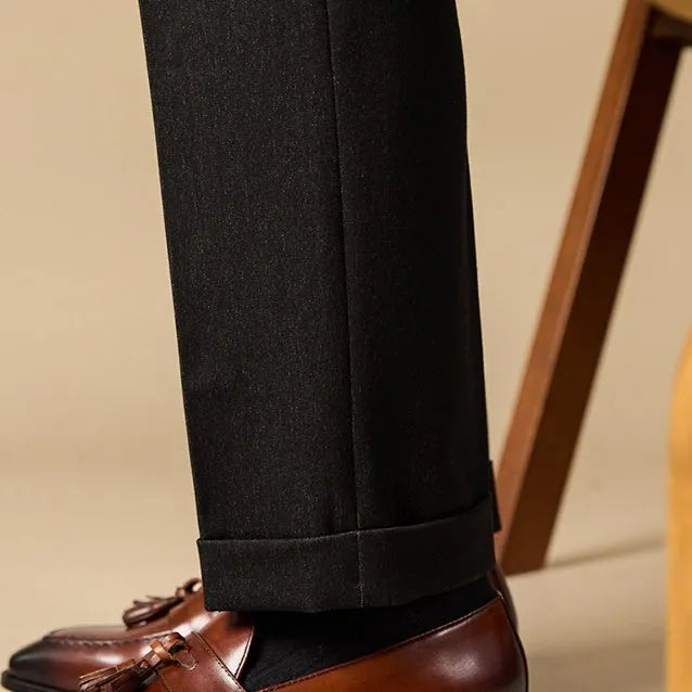 Men's black genuine leather tassel loafers with a rubber sole, shown from a side angle.