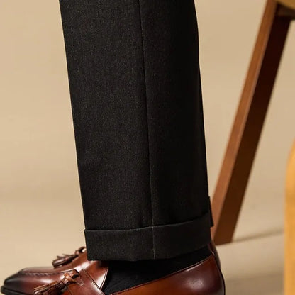 Men's black genuine leather tassel loafers with a rubber sole, shown from a side angle.