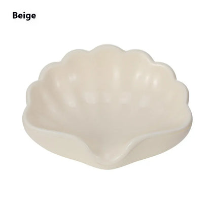 Plastic shell soap dish in pearl white, dimensions 12x9x5.5cm, on a bathroom counter