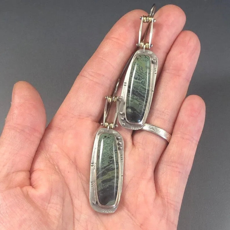 Two-tone geometric alloy earrings with a simple marble pattern, offering a lightweight design for all-day wear and versatile styling for casual and formal occasions.