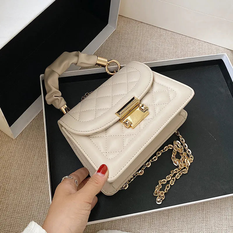 Beige rhombus-shaped women's crossbody bag with a long strap, showing front view and size.