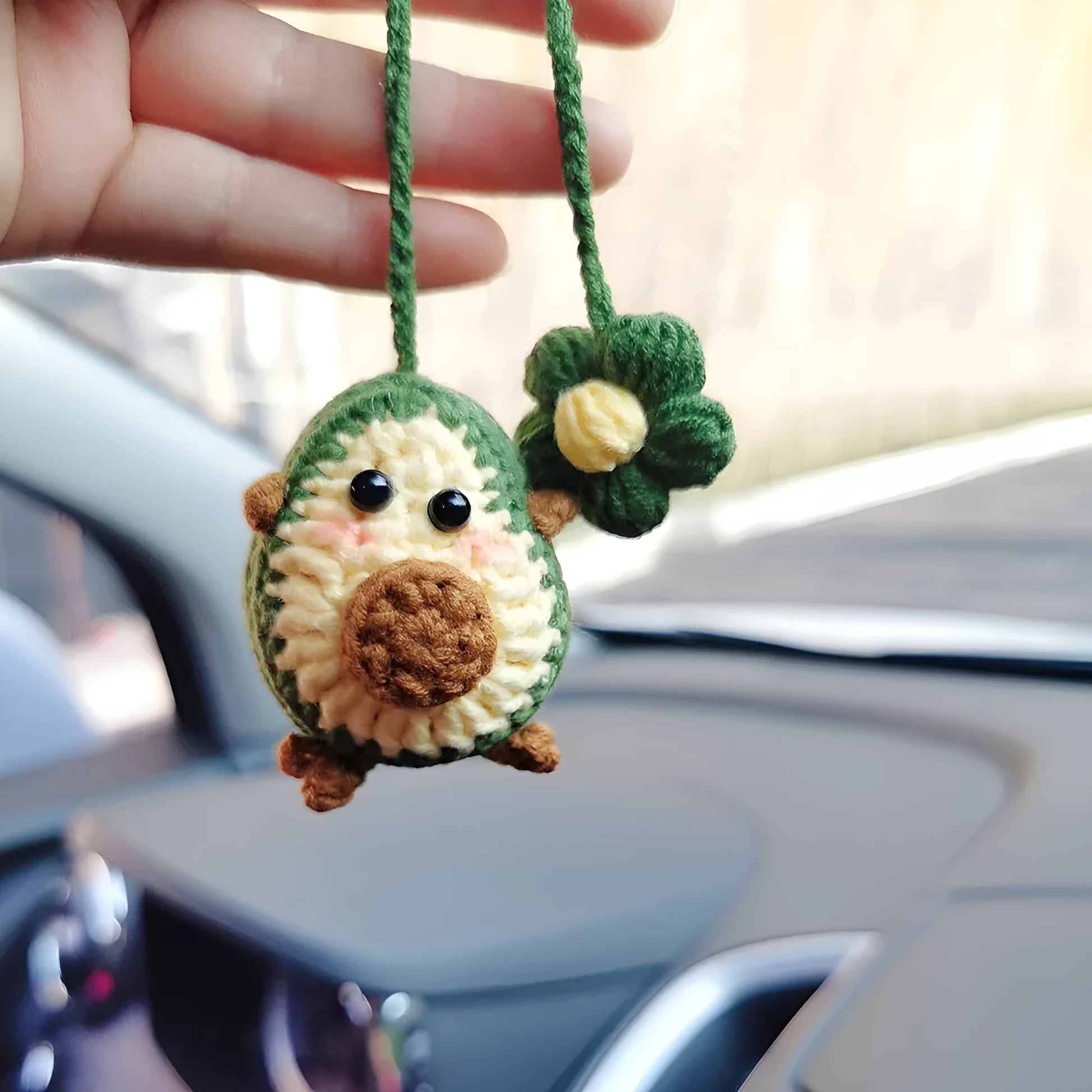 Handmade crocheted cartoon-style car pendant in wool, shown in avocado, pink rainbow, and red rainbow colour options.