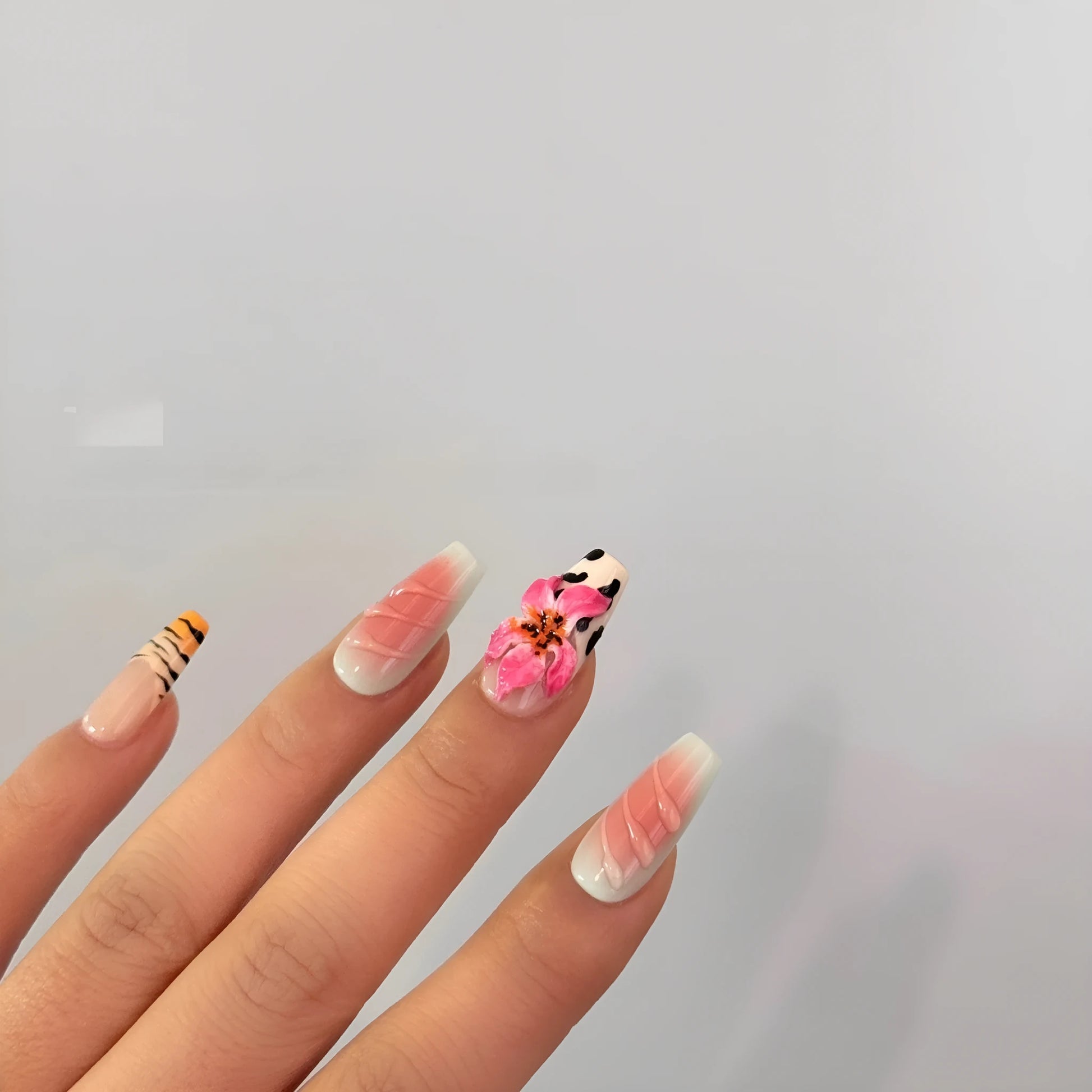 Hand-carved artificial nail art set with zebra pattern, embossed flowers, and leopard print in long length.