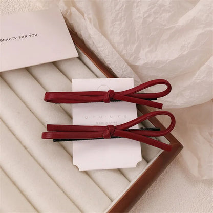 Wine red leather bow hair barrette with 2.5cm bow width and 5cm clip length