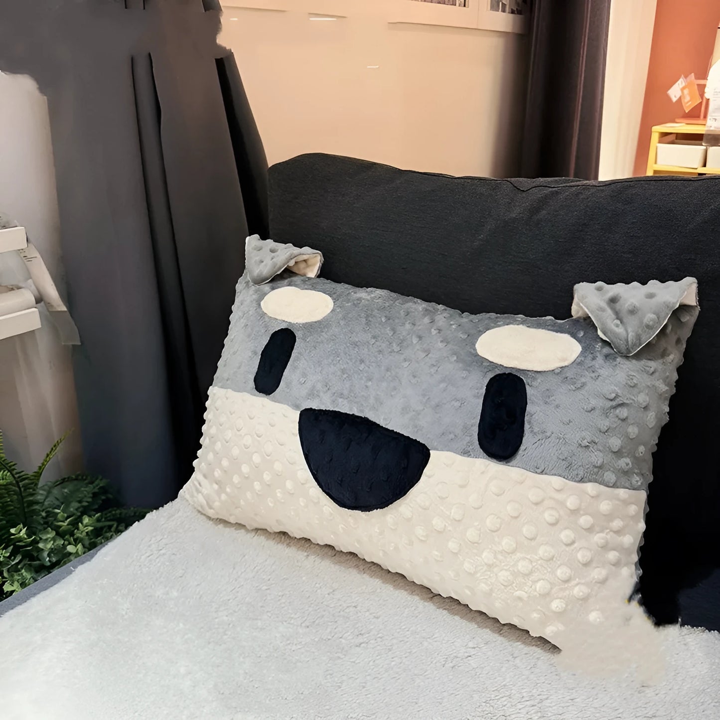 Grey schnauzer print dog pillow cushion on a sofa, measuring 50cm long.
