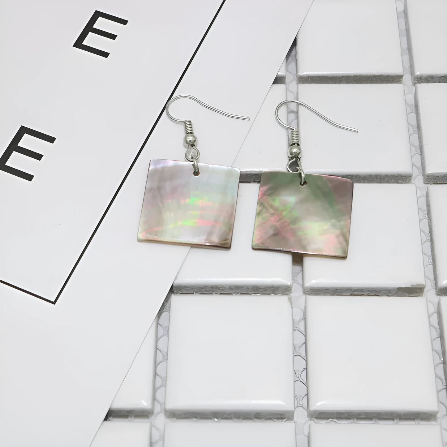 Natural shell earrings in geometric square and rectangular shapes with panther pattern detailing