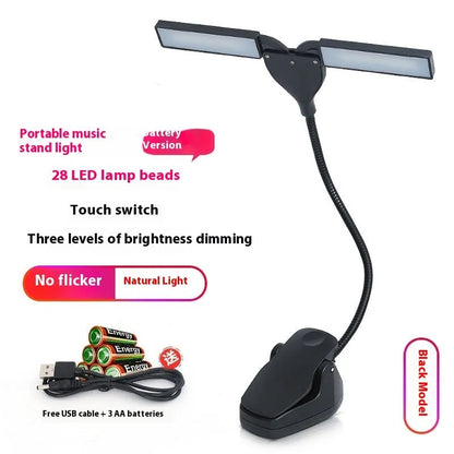 Black music stand light with flexible neck attached to metal music stand, illuminating sheet music