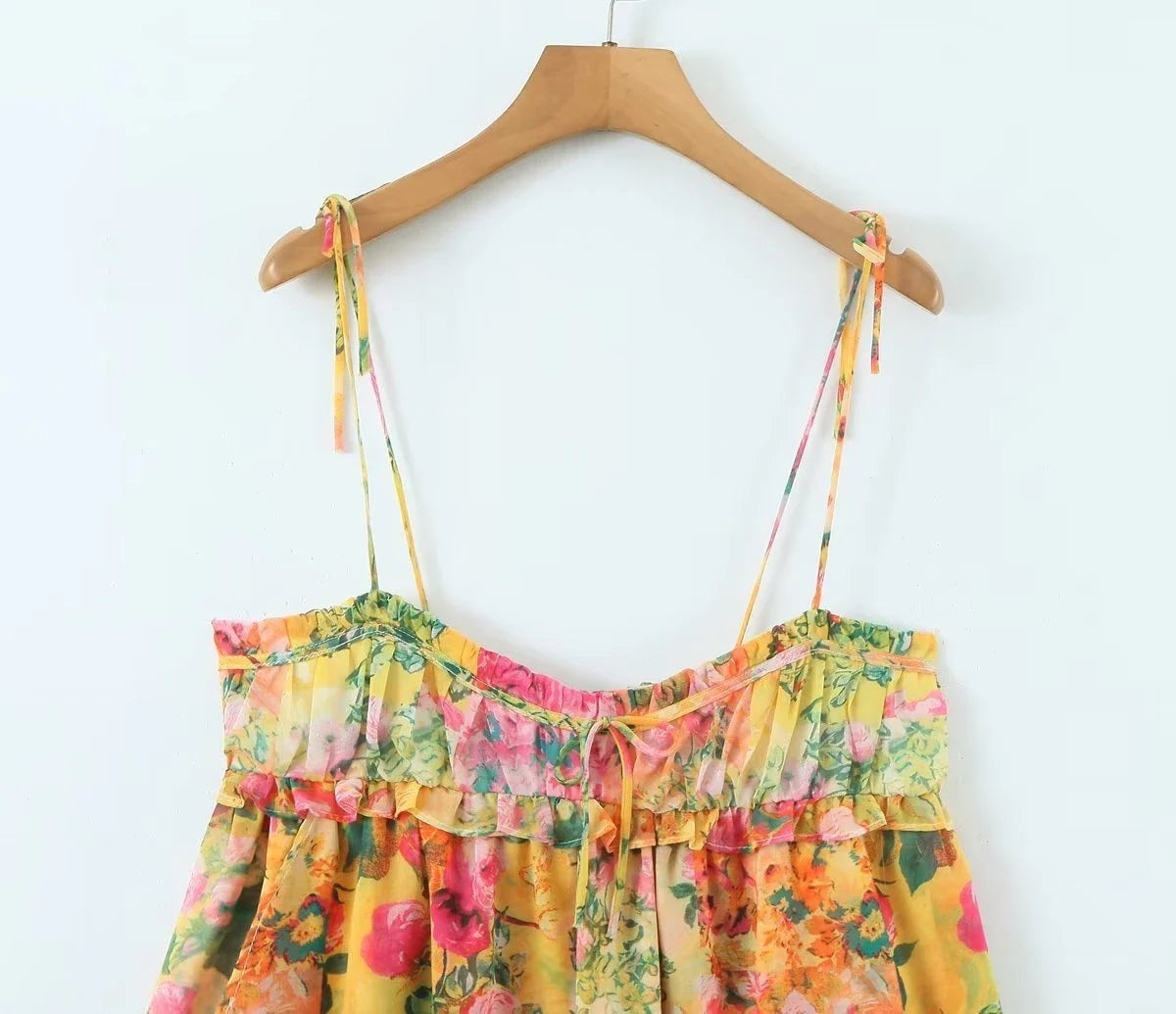 Elegant floral suspender dress with adjustable straps and A-line silhouette, perfect for summer fashion