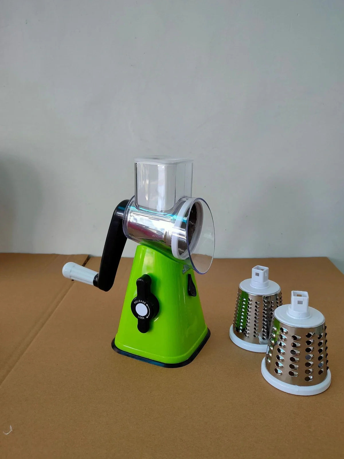 White plastic hand drum vegetable cutter slicer showing drum mechanism for even 0.5 cm vegetable slices, compact 20 cm size