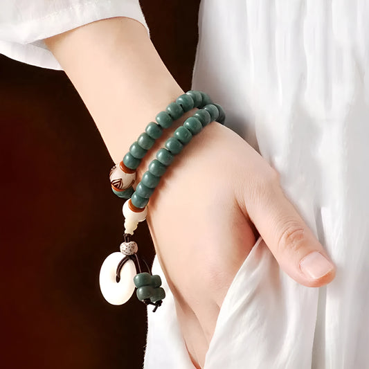 White jade bodhi and green sandalwood bracelet with a double ring safety buckle clasp.