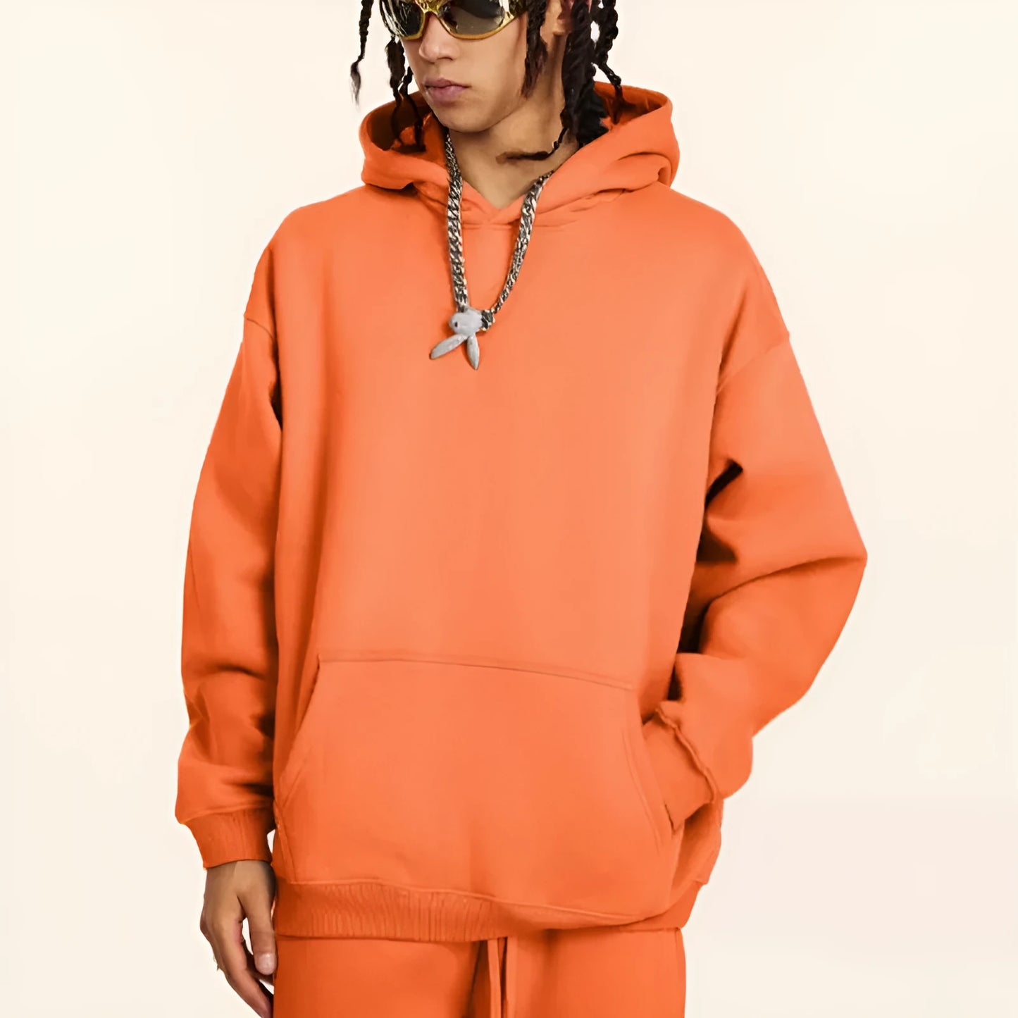 Men's grey terry hooded sweater with drop-shoulder sleeves and front pocket, showing textured cotton fabric