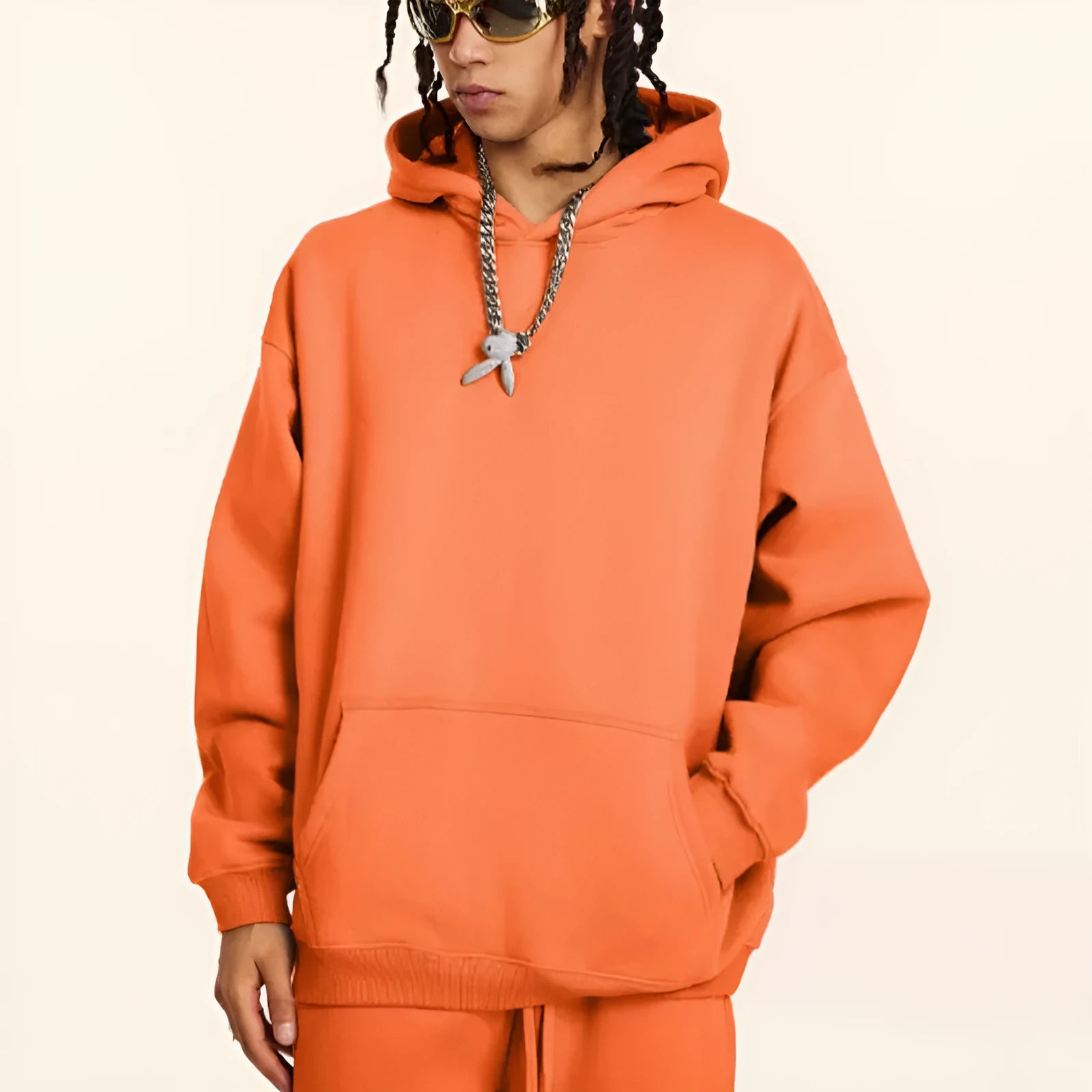 Men's grey terry hooded sweater with drop-shoulder sleeves and front pocket, showing textured cotton fabric