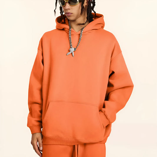 Men's grey terry hooded sweater with drop-shoulder sleeves and front pocket, showing textured cotton fabric