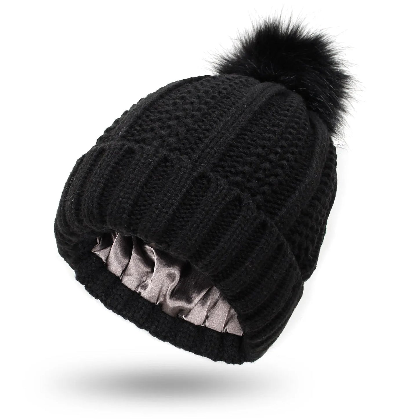 Wool knit beanie hat for women with faux fur pom pom and satin lining, shown in a wine red colour.