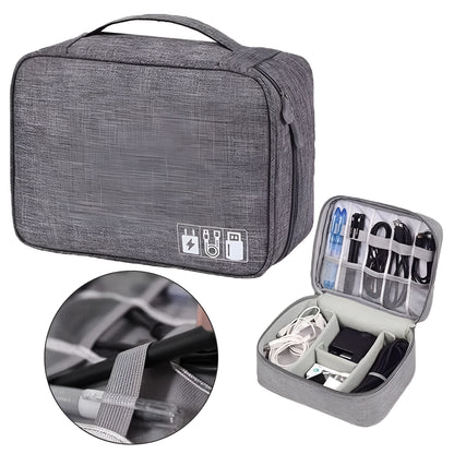 Black travel cable organiser bag open, showing mesh pockets, elastic loops, and removable padded dividers inside.