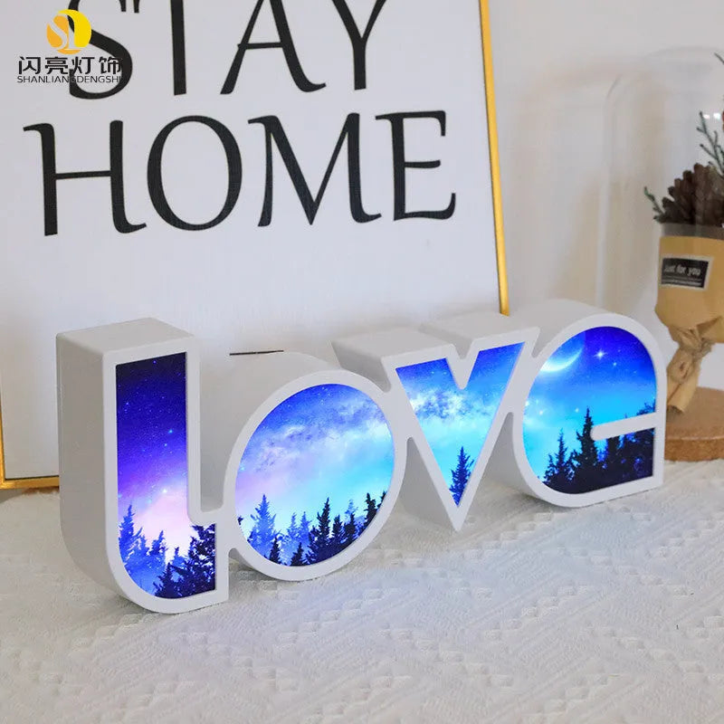 Rainbow halo LED love light with 'LOVE' word decoration on plastic casing.