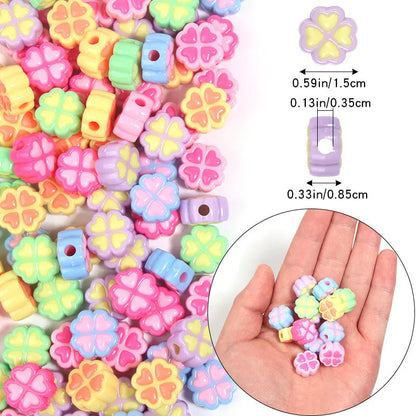 Assorted frosted acrylic four-leaf clover shaped beads in pink, green, and yellow, 15mm diameter.