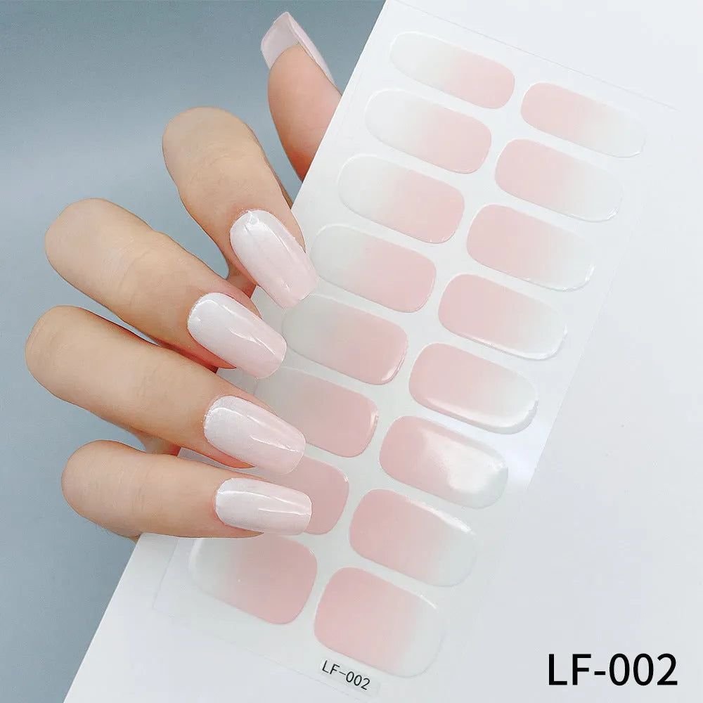 Sheet of 16 small design nail art stickers including cross, rose, tulip and marble patterns.