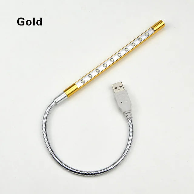 Spiral-shaped silver aluminium alloy USB LED desk lamp on a wooden table.