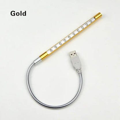 Spiral-shaped silver aluminium alloy USB LED desk lamp on a wooden table.