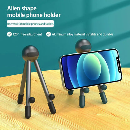 Aluminium alloy desktop phone and tablet stand with 120-degree adjustable angle, alien shape, green and pink options.