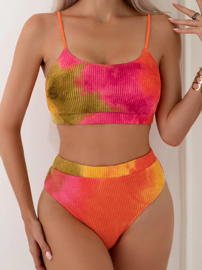 Women's tie-dye pleated split bikini with gradient pattern in polyester fabric showing orange and blue colour options