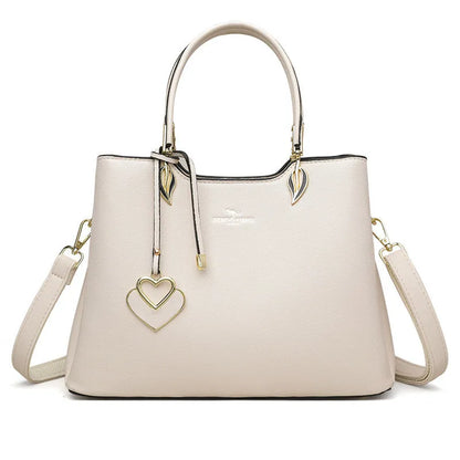 Women's black PU leather messenger bag with multi-layer shoulder strap and sewing thread detailing.