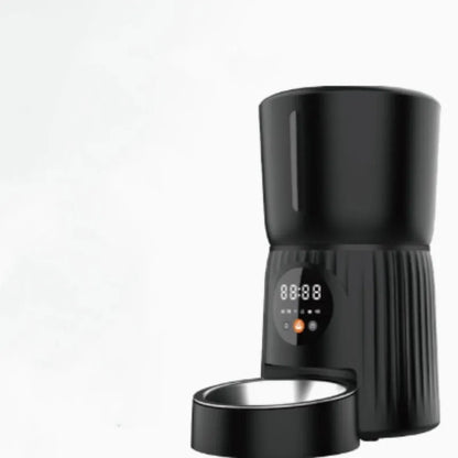 Black intelligent pet feeder with transparent food container showing kibble, digital display, and USB power cable